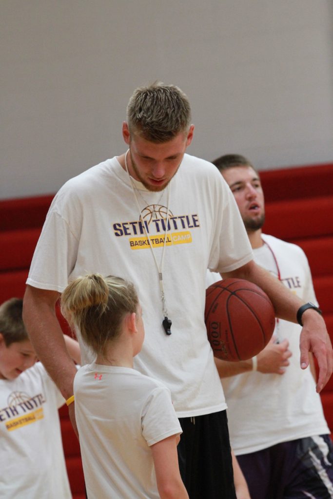 Seth Tuttle instructs kids at his basketball camp in Sheffield, Iowa this July