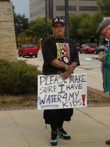 Sten Joddi protests the pipeline in Mason City, Iowa on Friday